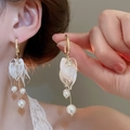 Model wearing gold petal earrings with pearls and tassels for an elegant French style - White Flower Pearl (109#)