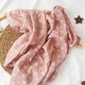 Pink muslin baby blanket featuring white daisy floral prints on a woven mat - Light Pink Daisy
