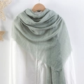 Solid light green crinkle cotton linen scarf with frayed edges hanging on a hanger - Pale Green