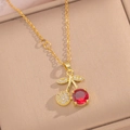 Elegant gold cherry pendant necklace with red gemstones and crystals in a jewelry box - Cherry Necklace
