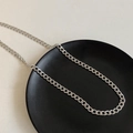 Silver stainless steel chain necklace with square pendants on a black decorative plate - Titanium Steel / Silver