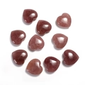 Macro shot of 20mm heart-shaped polished rose quartz gemstones on a white background - Strawberry Quartz