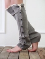 Close-up of grey knitted leg warmers with white lace trim and black button details - One Size / Light Gray