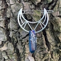 Silver hollow moon hair clip featuring a rainbow crystal prism and star charm on wood - Deep Blue Crystal