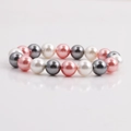 Pink, grey, and white shell pearl beads for DIY bracelets on a reflective white surface - Pink Gray White Tri-color Shell Pearl