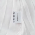 Detail shot of the 100% polyester fabric care label on a white printed mini dress - S / Oil Painting Pink