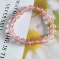 Close-up of 8mm pink cat eye stone bracelet with smooth round beads and glossy finish - Watermelon red