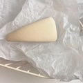 Detail of a beige twill fabric triangle hair clip on a clean white textured background - Apricot