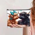 Detail showing hand holding a large capacity Highland Cow print makeup bag with zipper - Highland Cow with Blue Bow & Black Cow (jiayingpbb0115)
