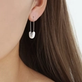 French luxury silver safety pin earring with white bead charm on model ear - White/Silver