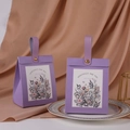 Detail of purple floral gift box with leather handle and golden metal rivets - Leather Handle Style / Purple