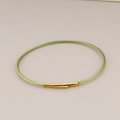 Light green stainless steel wire rope bracelet with a gold-colored snap closure - Cyan Rope Gold Clasp