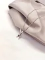 Mechanical silver rabbit necklace with Luck engraving on champagne silk background - Silver