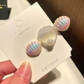 Close-up of shell hair clip with iridescent pearl detailing on white display card - 8* Mermaid Pearl Shell - White