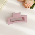Matte light pink rectangular claw clip on minimalist beige background with roses - Matte Light Pink Hollow Hair Claw