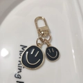 Smiling face keychain with black enamel and gold finish on white ceramic dish - Small & Large Set Black