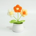 Close-up of handmade crochet puff flowers in a white ceramic pot with vibrant petals - Puff Flower Yellow