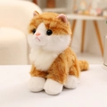 Realistisches orange-weißes Katzenstofftier in Sitzposition mit weichem Langhaar - 20cm / Orangene Katze