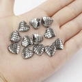 Macro shot of 12 heart-shaped fish scale resin charms held in a palm for DIY crafts - 12mm Gun Grey