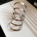 Detailed macro view of 5-layer silver cuff bracelet with hammered and polished textures - Spiral Multi-layer Armlet / Silver