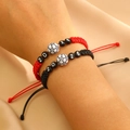 Detail of hand-woven 2026 soccer bracelets with adjustable cords on wrist - Red And Black Braided Style