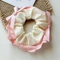 Detailed close-up of pink and white lace scrunchie with cute satin ribbon bows - Pink Bubble Texture
