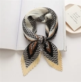 Detail of pleated silk scarf featuring houndstooth pattern and geometric color blocks - Beige Black Houndstooth