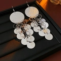 Macro detail of silver sequin tassel earrings on a premium black leather jewelry box - Earring Hooks - Silver