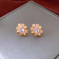 Macro view of gold flower earrings with an oval purple stone and pavé crystal petals - Silver Needle - Gold - Light Purple Zircon