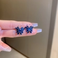 Detailed view of deep blue butterfly stud earrings with sparkling crystals and silver base - Blue Zirconia Butterfly Stud