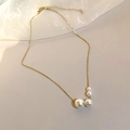 Detail of gold chain necklace featuring four gradient white pearls on soft beige fabric - 2# Necklace-Gold Gradient Pearl