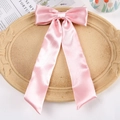 Pink satin bow hair clip with long ribbons on a decorative beige tray accessory - Duckbill Hair Clips / Pink