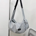 Light gray waterproof nylon crossbody sports bag with wide adjustable black shoulder strap - Gray