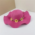 Detail of rose red straw sun hat with wavy brim and daisy floral band decoration - Rose Red