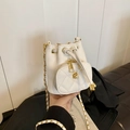 Mini white drawstring bucket bag with quilted pocket and golden camellia flower detail - White