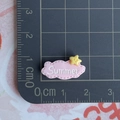 Macro view of a 2cm pink cloud resin accessory with Summer text and star on a scale mat - Pink Summer Word Sign
