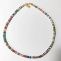 Detail of colorful beaded necklace with golden lobster clasp and butterfly charm pendant - Rainbow Mixed Multicolor
