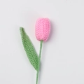Close-up of pink handmade crochet tulip with green stem in high-quality wool texture - Finished Closed Tulip (bright Pink)