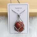 Silver metal mesh cage necklace featuring a red jasper stone pendant on a white card - Silver Red Jasper