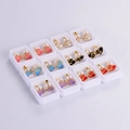 Close-up of 12 pairs of colorful cartoon cat stud earrings in individual white boxes - Cartoon Cat Style (12 Pairs)