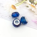 Blue faceted acrylic beads with silver metal cores on white wood for DIY jewelry - Blue