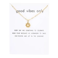Detailed view of a gold sun pendant necklace on a minimalist decorative display card - Sun White Card (YH6499) / Gold