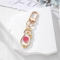 Pink real dried flower cat-shaped keychain with gold alloy frame on white stone - Pink Flower Kitten