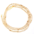 Faceted orange natural stone beads for DIY jewelry making on white background - Rutilated Quartz Gold