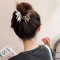 Silver metal bat-shaped hair claw clip on model showing minimalist gothic aesthetic style - Silver