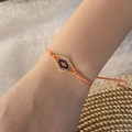 Bohemian woven seed bead bracelet with gold and orange diamond pattern on model wrist - Orange