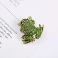 Close-up of a green frog brooch with gold spots and sparkling green gemstone eyes - Bright Green Gold Dots Style