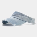 Close-up of distressed denim sun visor with ripped brim and twill texture details - Adjustable / Light Blue