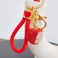 Detail of a sparkly rhinestone apple keychain with red braided rope and gold heart charm - Lychee with Heart Lanyard