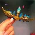 Detailed shot of golden moon and wing bridal headband featuring blue crystals - Dark Blue Crystal + Gold Wing Moon